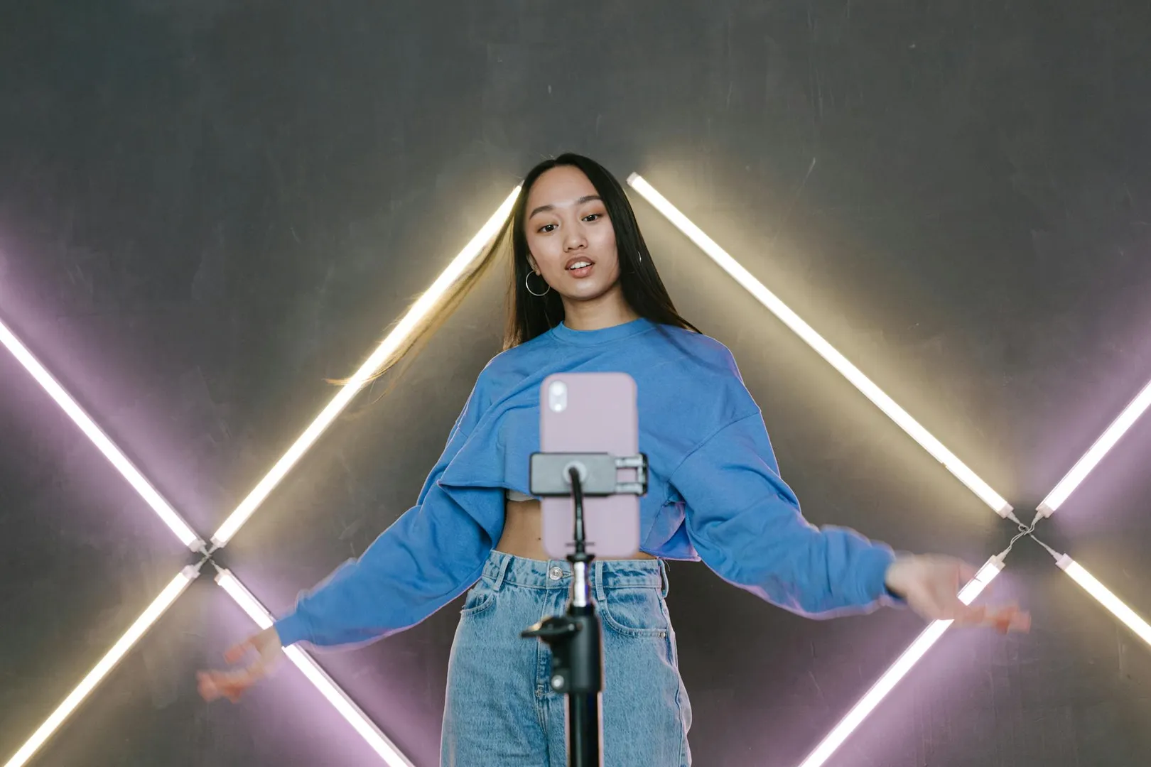 Influencer recording short-form video content with smartphone camera setup
