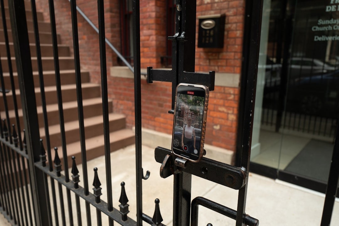 A cell phone is attached to a fence